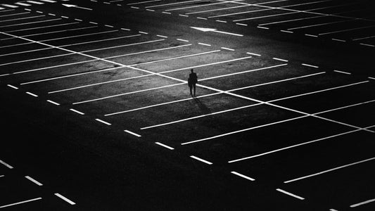 solo winning mindset - person in dark car park 